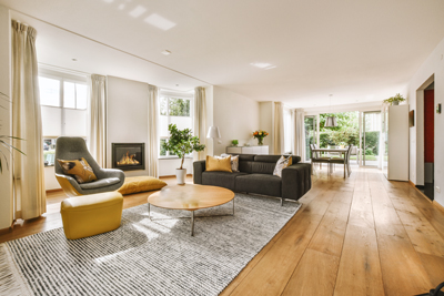 spacious modern living room featuring comfortable seating elegant decor and natural light with a cozy fireplace and garden view